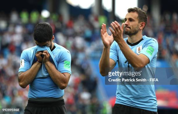 Luis Suarez of Uruguay looks dejected while Cristhian Stuani acknowledges the fans following their sides defeat in the 2018 FIFA World Cup Russia...