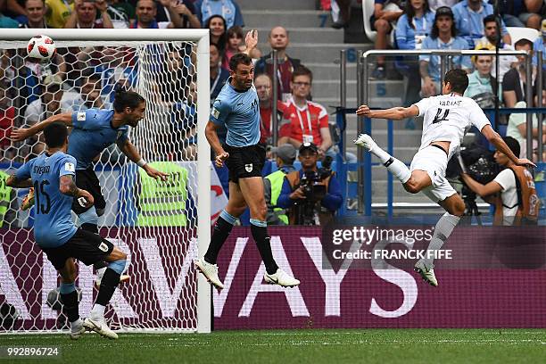 France's defender Raphael Varane heads the ball to score a goal during the Russia 2018 World Cup quarter-final football match between Uruguay and...