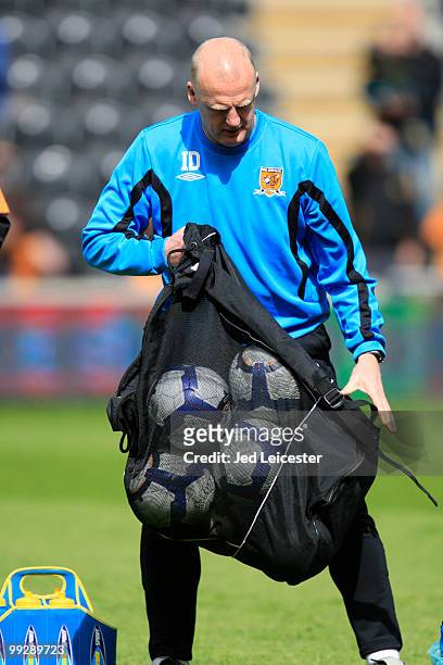 Hull City interim manager Iain Dowie collects up the balls during the Barclays Premier League match between Hull City and Liverpool at the KC Stadium...