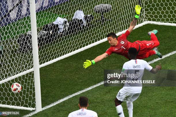 Uruguay's goalkeeper Fernando Muslera dives to concede a goal during the Russia 2018 World Cup quarter-final football match between Uruguay and...