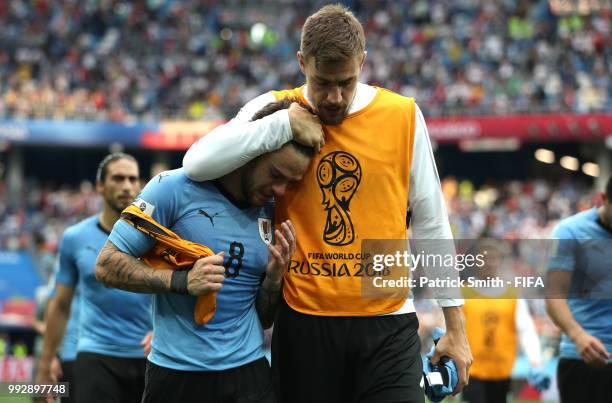 Sebastian Coates of Uruguay consoles teammate Nahitan Nandez of Uruguay following Uruguay's defeat during the 2018 FIFA World Cup Russia Quarter...