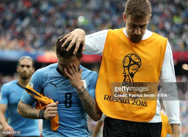 Sebastian Coates of Uruguay consoles teammate Nahitan Nandez of Uruguay following Uruguay's defeat during the 2018 FIFA World Cup Russia Quarter...