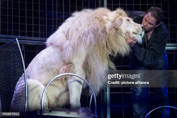 Animal trainer Martin Lacey presents the feline predator show during the premiere of the Circus Krone at the Cannstatter Wasen in Stuttgart, Germany,...