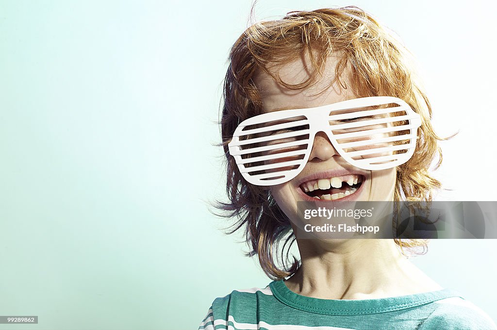 Boy smiling wearing sunglasses