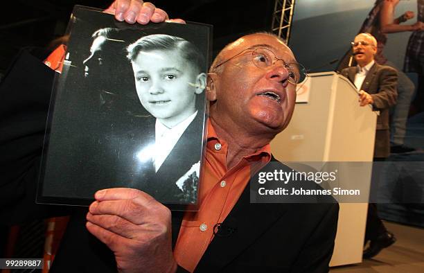 Norbert Denef , head of the association NetzwerkB and victim of sexual abuse of a priest protests with a photography during the speech of Klaus...