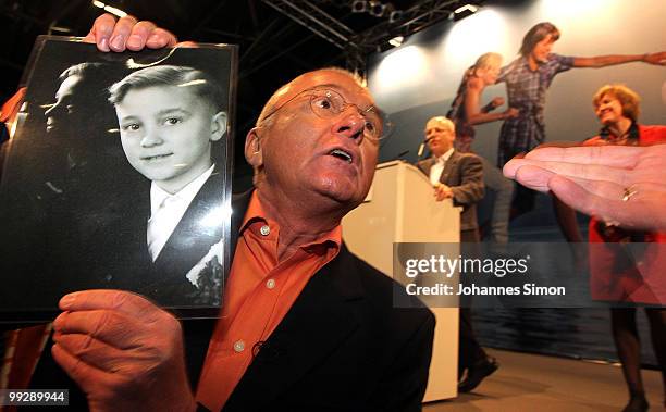 Norbert Denef , head of the association NetzwerkB and victim of sexual abuse of a priest protests with a photography during the speech of Klaus...