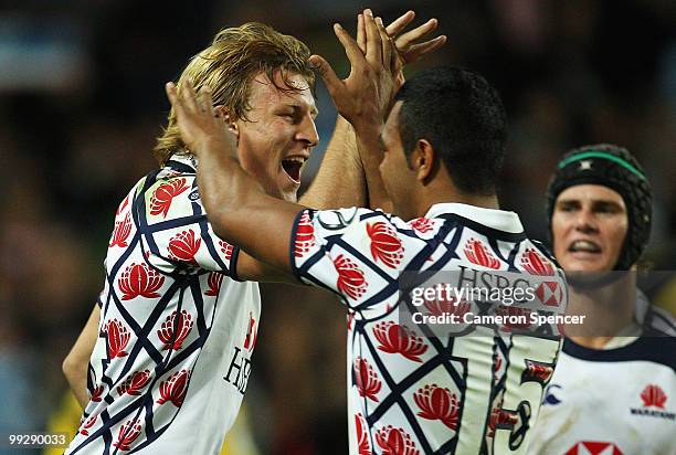 Kurtley Beale of the Waratahs congratulates team mate Lachie Turner after setting up a try during the round 14 Super 14 match between the Waratahs...