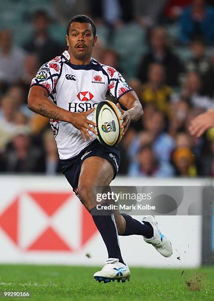 Kurtley Beale of the Waratahs runs the ball during the round 14 Super 14 match between the Waratahs and the Hurricanes at Sydney Football Stadium on...