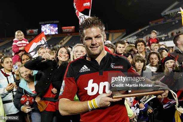 Crusaders captain Richie McCaw poses with an award for his 100th Super rugby game after the round 14 Super 14 match between the Crusaders and the...