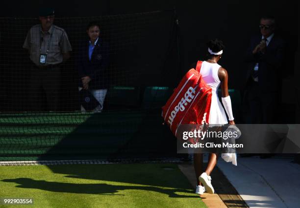 Venus Williams of the United States walks off court after losing to Kiki Bertens of the Netherlands during their Ladies' Singles third round match on...