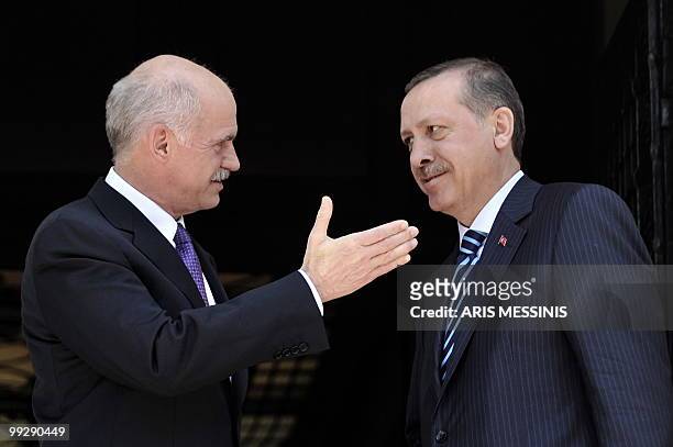 Greek Premier George Papandreou speaks with his Turkish counterpart Recep Tayyip Erdogan before their meeting in Athens on May 14, 2010. Turkey's...