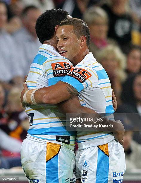 Scott Prince and Joseph Tomane of the Titans celebrate after a try during the round 10 NRL match between the Brisbane Broncos and the Gold Coast...