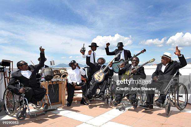 Staff Benda Bilili perform at the 'Benda Bilili' Photo Call held at the Palais Stephanie Roof Terrace during the 63rd Annual International Cannes...