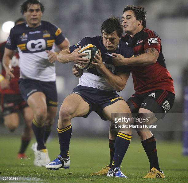 Adam Ashley-Cooper of the Brumbies is tackled by Zac Guilford of the Crusaders during the round 14 Super 14 match between the Crusaders and the...