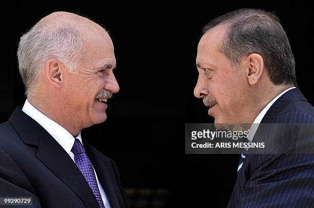 Greek Premier George Papandreou speaks with his Turkish counterpart Recep Tayyip Erdogan before their meeting in Athens on May 14, 2010. Erdogan is...