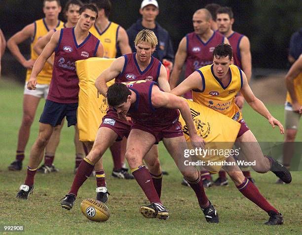 Jason Akermanis , Jonathan Brown and Beau McDonald of the Lions in action during a team training session held at the Brisbane Lions Training ground,...