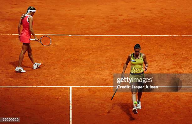 Flavia Pennetta of Italy kicks the ball flanked by her doubles partner Gisela Dulko of Argentina in their semi-final doubles match against Maria Jose...