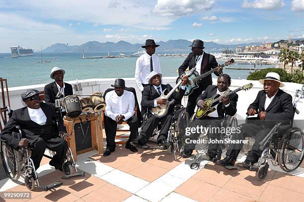 Staff Benda Bilili perform during a photo call held at the Palais Stephanie Roof Terrace during the 63rd Annual International Cannes Film Festival on...
