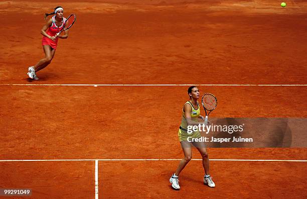 Flavia Pennetta of Italy eyes the ball with her doubles partner Gisela Dulko of Argentina in their semi-final doubles match against Maria Jose...