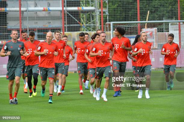 Goalkeeper Sven Ulreich of Muenchen, Arjen Robben of Muenchen, Franck Ribery of Muenchen and Rafinha of Muenchen run during a training session of FC...