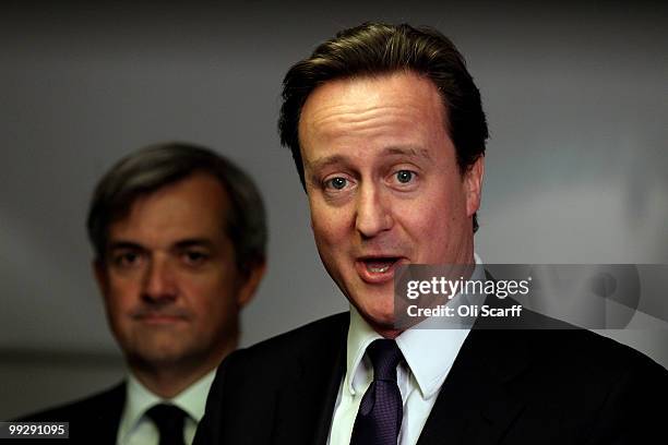 British Prime Minister David Cameron speaks next to Chris Huhne, the Secretary of State for Energy and Climate Change, during address to DECC staff...