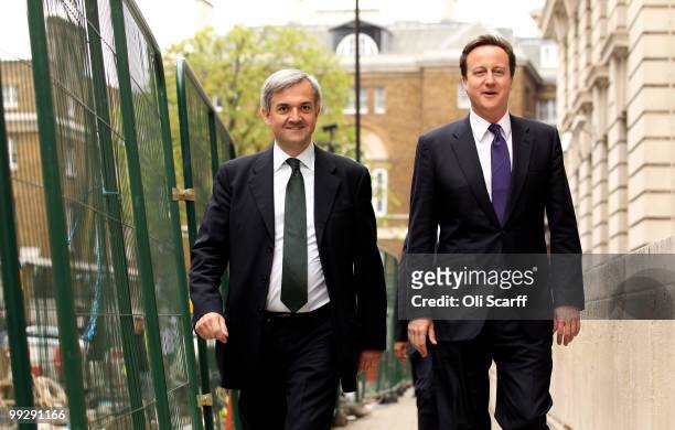 British Prime Minister David Cameron arrives with Chris Huhne, the Secretary of State for Energy and Climate Change, during a visit to the DECC on...