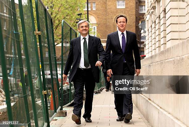 British Prime Minister David Cameron arrives with Chris Huhne, the Secretary of State for Energy and Climate Change, during a visit to the DECC on...