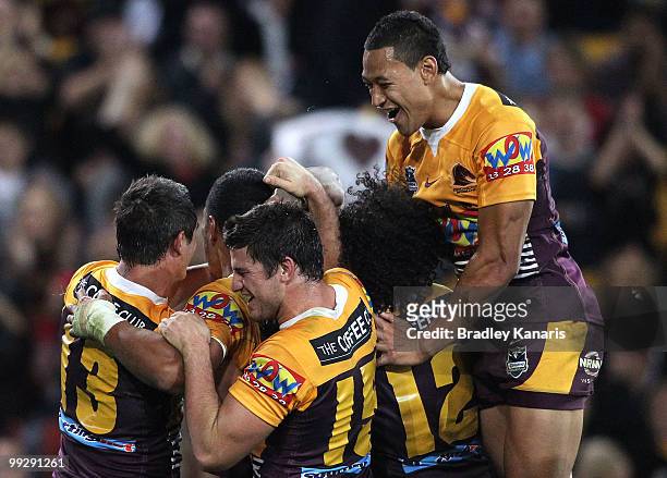 Broncos players celebrate a try by team mate Lagi Setu during the round 10 NRL match between the Brisbane Broncos and the Gold Coast Titans at...