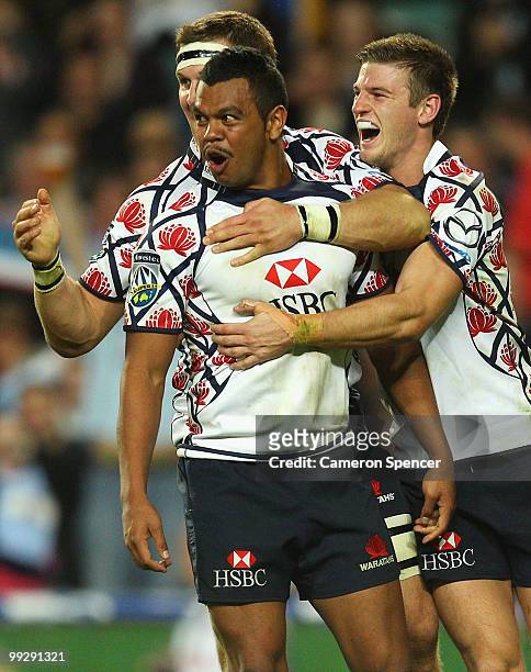 Kurtley Beale of the Waratahs celebrates scoring a try with team mates during the round 14 Super 14 match between the Waratahs and the Hurricanes at...