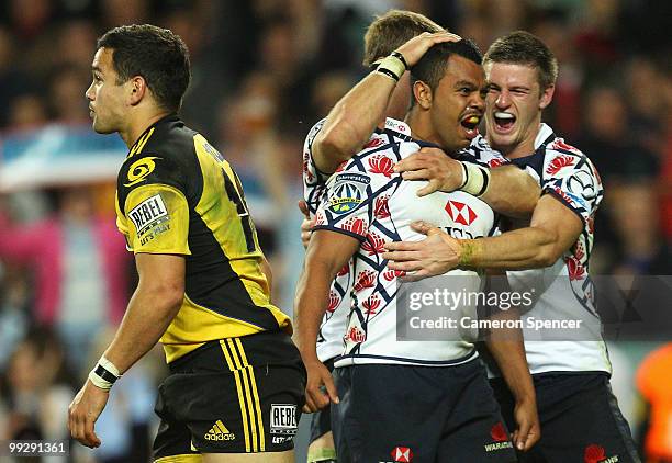 Kurtley Beale of the Waratahs celebrates scoring a try with team mates during the round 14 Super 14 match between the Waratahs and the Hurricanes at...