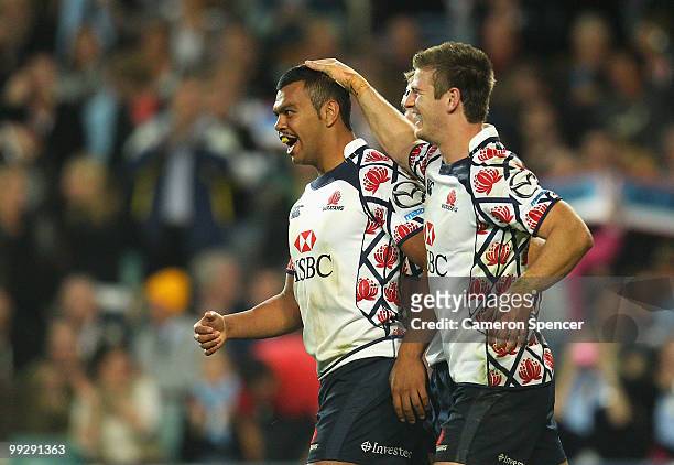 Kurtley Beale of the Waratahs celebrates scoring a try with team mates during the round 14 Super 14 match between the Waratahs and the Hurricanes at...