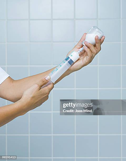 nurse drawing up injection, close-up - newhealth stock pictures, royalty-free photos & images