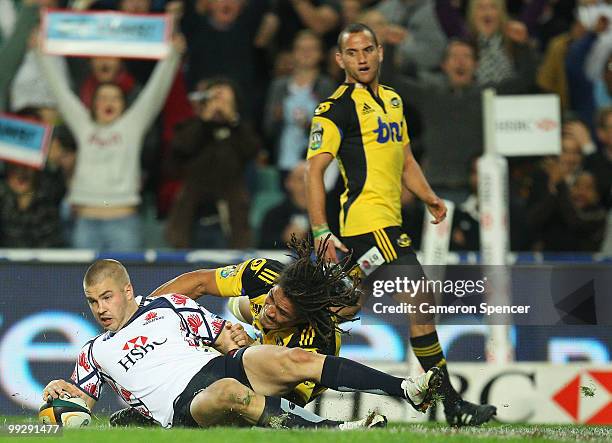 Drew Mitchell of the Waratahs scores a try during the round 14 Super 14 match between the Waratahs and the Hurricanes at Sydney Football Stadium on...