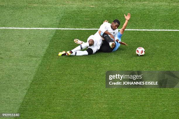 France's midfielder Paul Pogba fouls Uruguay's forward Cristhian Stuani during the Russia 2018 World Cup quarter-final football match between Uruguay...