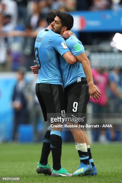 Luis Suarez of Uruguay ls consoled by Diego Godin of Uruguay at the end of the 2018 FIFA World Cup Russia Quarter Final match between Uruguay and...