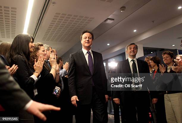 British Prime Minister David Cameron arrives with Chris Huhne , the Secretary of State for Energy and Climate Change, to address the staff in the...