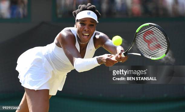 Player Venus Williams returns against Netherlands' Kiki Bertens during their women's singles third round match on the fifth day of the 2018 Wimbledon...