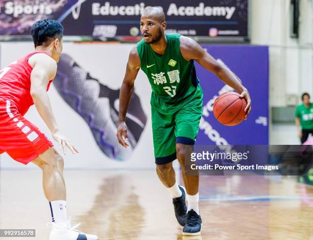Austin Bryant M of Tycoon Basketball Team handles the ball against the SCAA during the Hong Kong Basketball League playoff game between SCAA and...