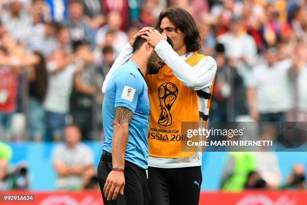 Uruguay's forward Edinson Cavani comforts Uruguay's forward Luis Suarez after the team lost the Russia 2018 World Cup quarter-final football match...