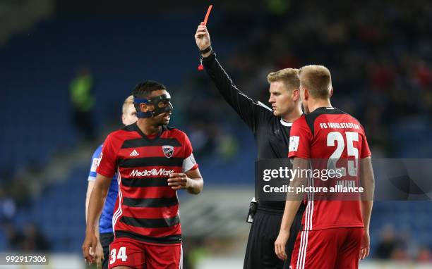 Referee Timo Gerach shows Marcel Gaus of Ingolstadt the yellow card, while Marvin Matip and Hauke Wahl look on, during the German 2nd Bundesliga...