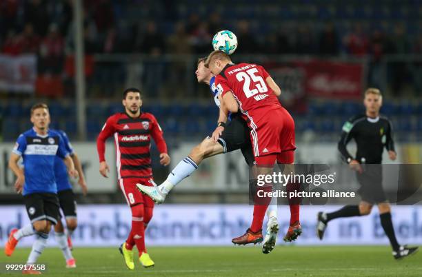 Bielefeld's Fabian Klos and Hauke Wahl of Ingolstadt vie for the ball during the German 2nd Bundesliga football match between Arminia Bielefeld and...