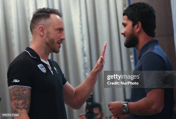 South Africa's cricket captain Faf du Plessis speaks to Sri Lanka's cricket captain Dinesh Chandimal after a media briefing in Colombo, Sri Lanka,...