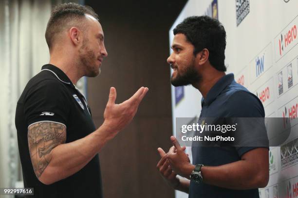 South Africa's cricket captain Faf du Plessis speaks to Sri Lanka's cricket captain Dinesh Chandimal after a media briefing in Colombo, Sri Lanka,...