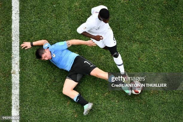 Uruguay's midfielder Cristian Rodriguez vies for the ball with France's midfielder Paul Pogba during the Russia 2018 World Cup quarter-final football...