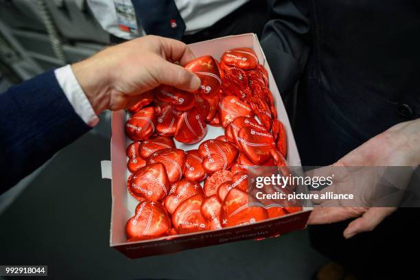 Dpatop - An Air Berlin stewardess hands out chocolate hearts to passengers after landing in Munich, Germany, 27 October 2017. Photo: Gregor...