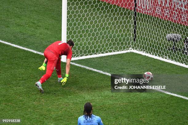 Uruguay's goalkeeper Fernando Muslera deflects the ball into his net during the Russia 2018 World Cup quarter-final football match between Uruguay...