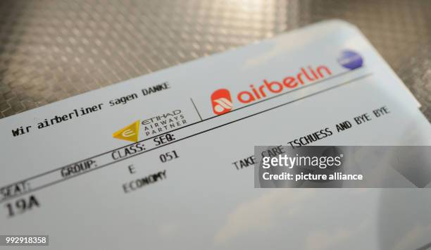 Dpatop - A boarding card that reads "Wir airberliner sagen DANKE - Take Care Tschuess and Bye Bye" on a table in the terminal at the airport in...