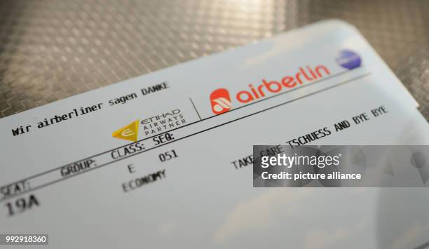 Boarding card that reads "Wir airberliner sagen DANKE - Take Care Tschuess and Bye Bye" on a table in the terminal at the airport in Munich, Germany,...