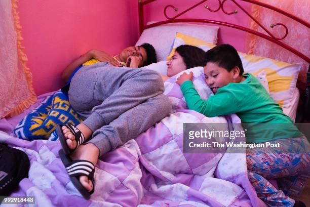 Lourdes Quintana-Salazar, 16 is playfully woken up by her brother, Bryan Quintana-Salazar, 14 and cousin, Pedro Salazar Bolanos, 8. MUST CREDIT:...