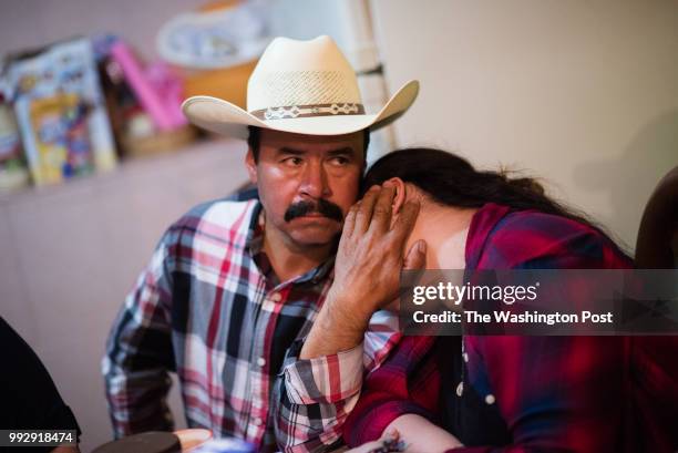 Luis Quintana left, gives his daughter, Lourdes Quintana-Salazar a hug in her grandmother's kitchen. He lived without his family for 7 years after he...